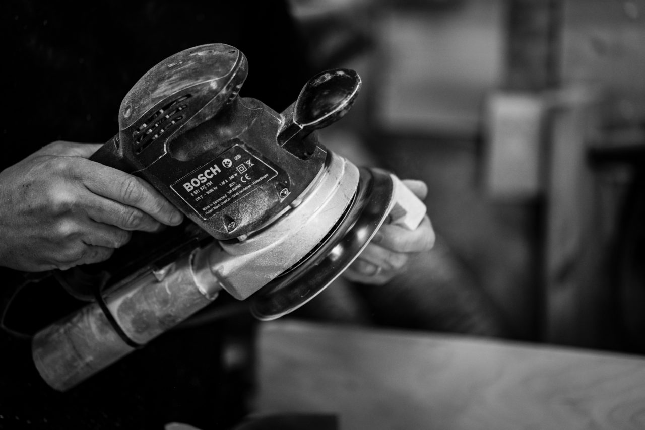 Person holding random orbital sander